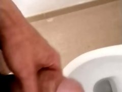 Hot and hung guy filming his dick while jerking off an cum into the toilet sink.